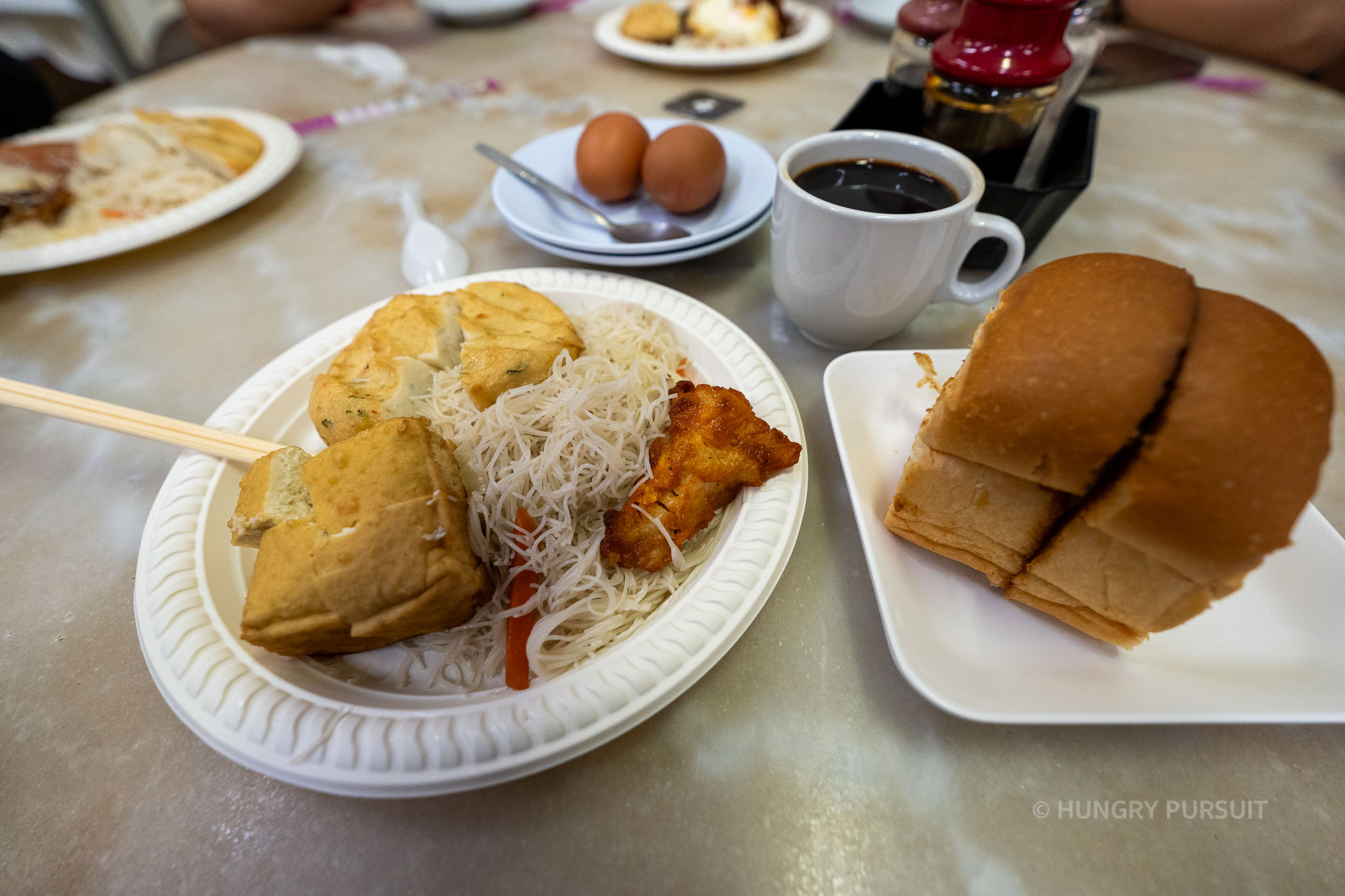 Delicious spread of traditional Singaporean food including kaya toast, coffee, and local delicacies at YY Kafei Dian