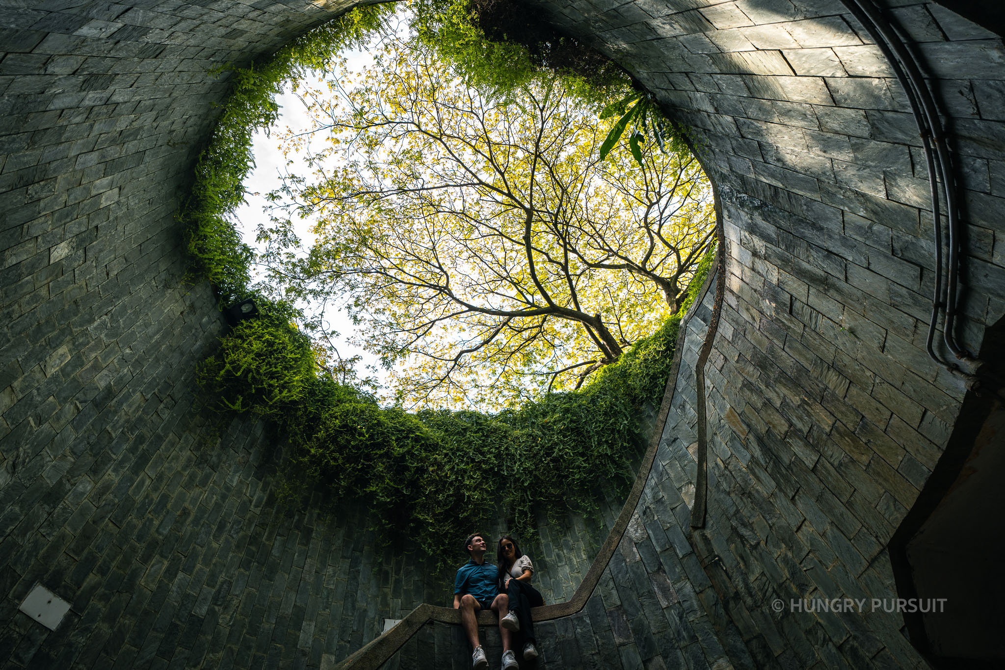 Couple posing inside the historic Fort Canning Tunnel, a popular Singapore landmark.