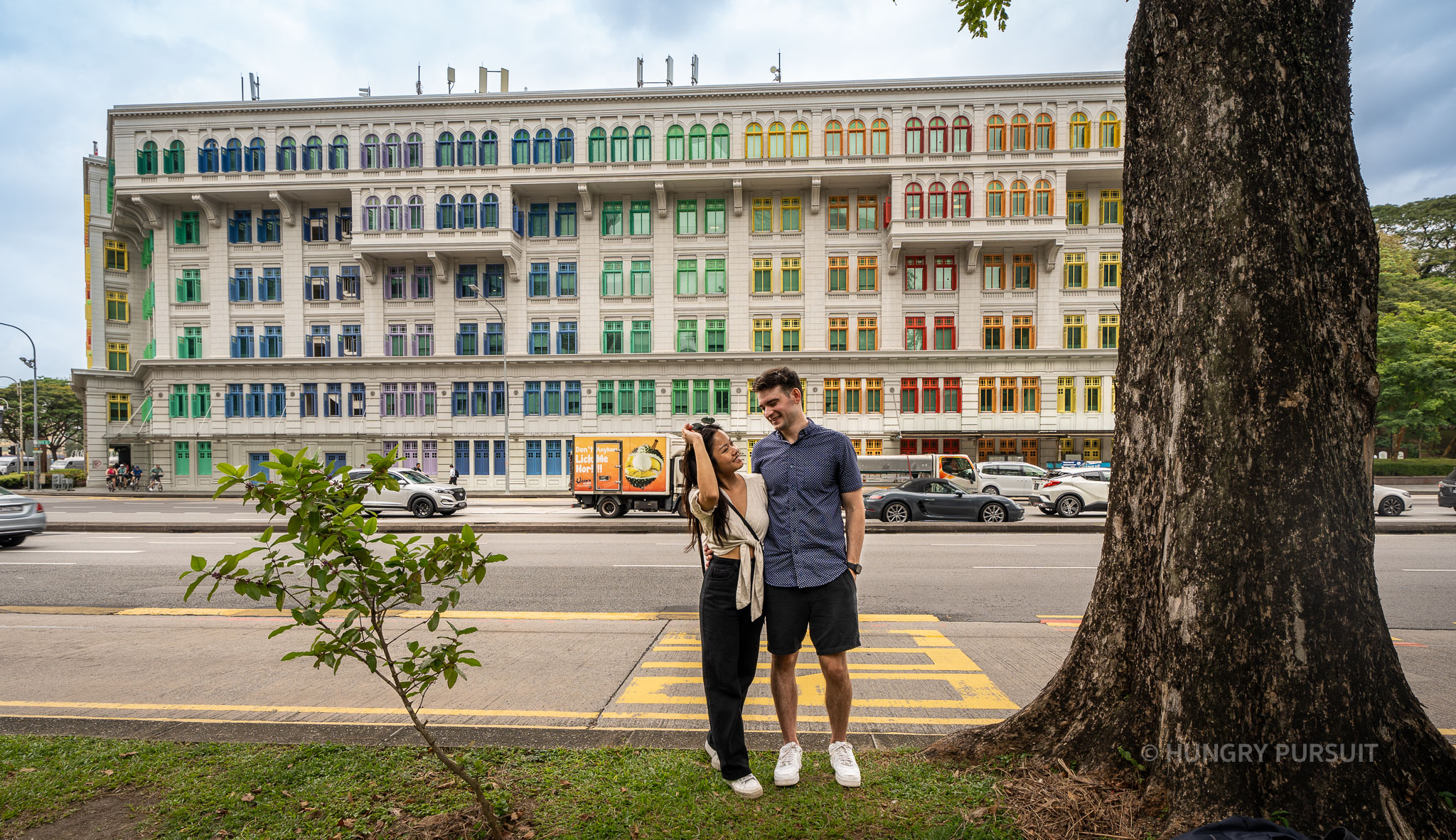 Couple posing in front of the historic Old Tree Hill Police Station in Singapore.