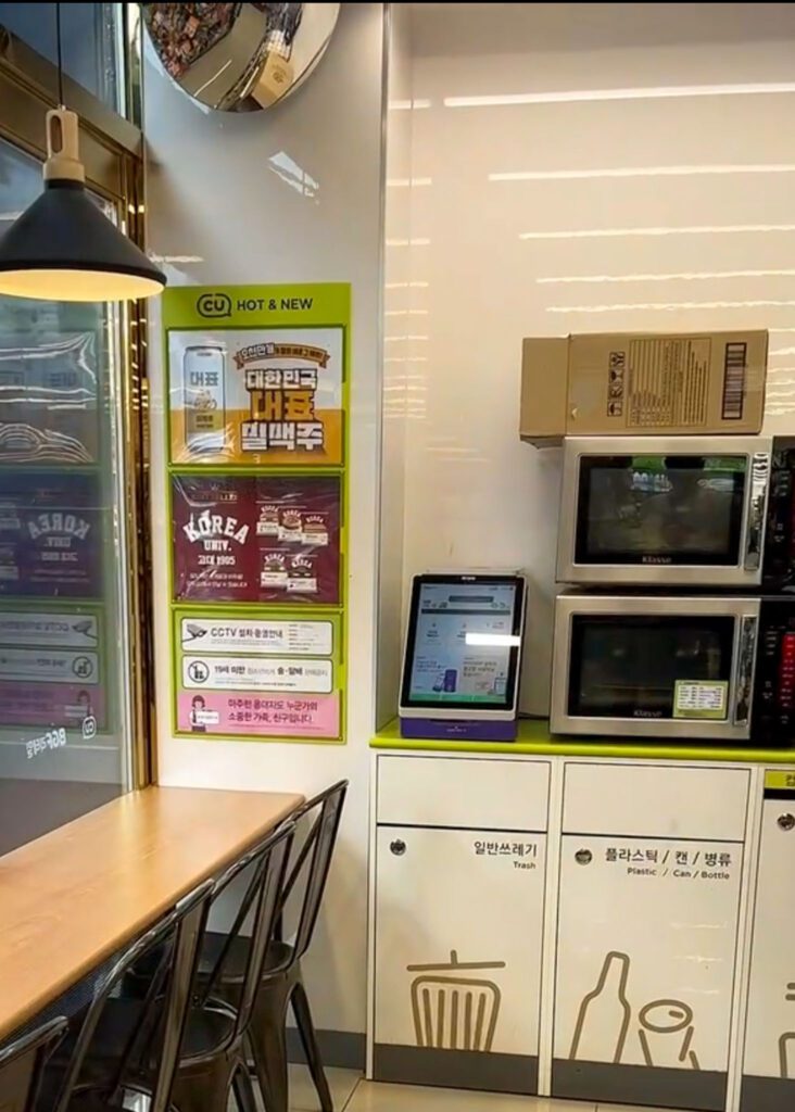 a cooking station and microwaves at a korean convenience store.