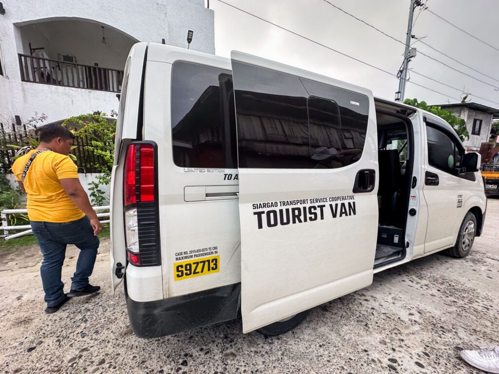 Shuttle bus picking up passengers at Siargao Airport, offering convenient transport to their hotels