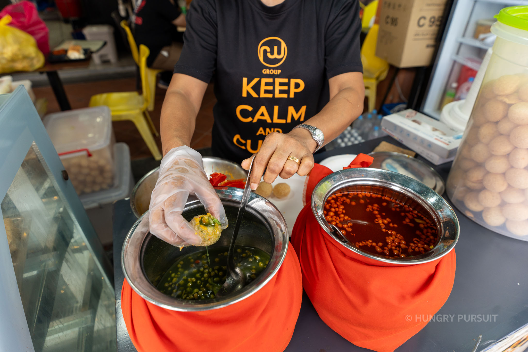 Lady serving Pani Puri, a popular Indian street food, at Mithai Mandir in Little India, Singapore.