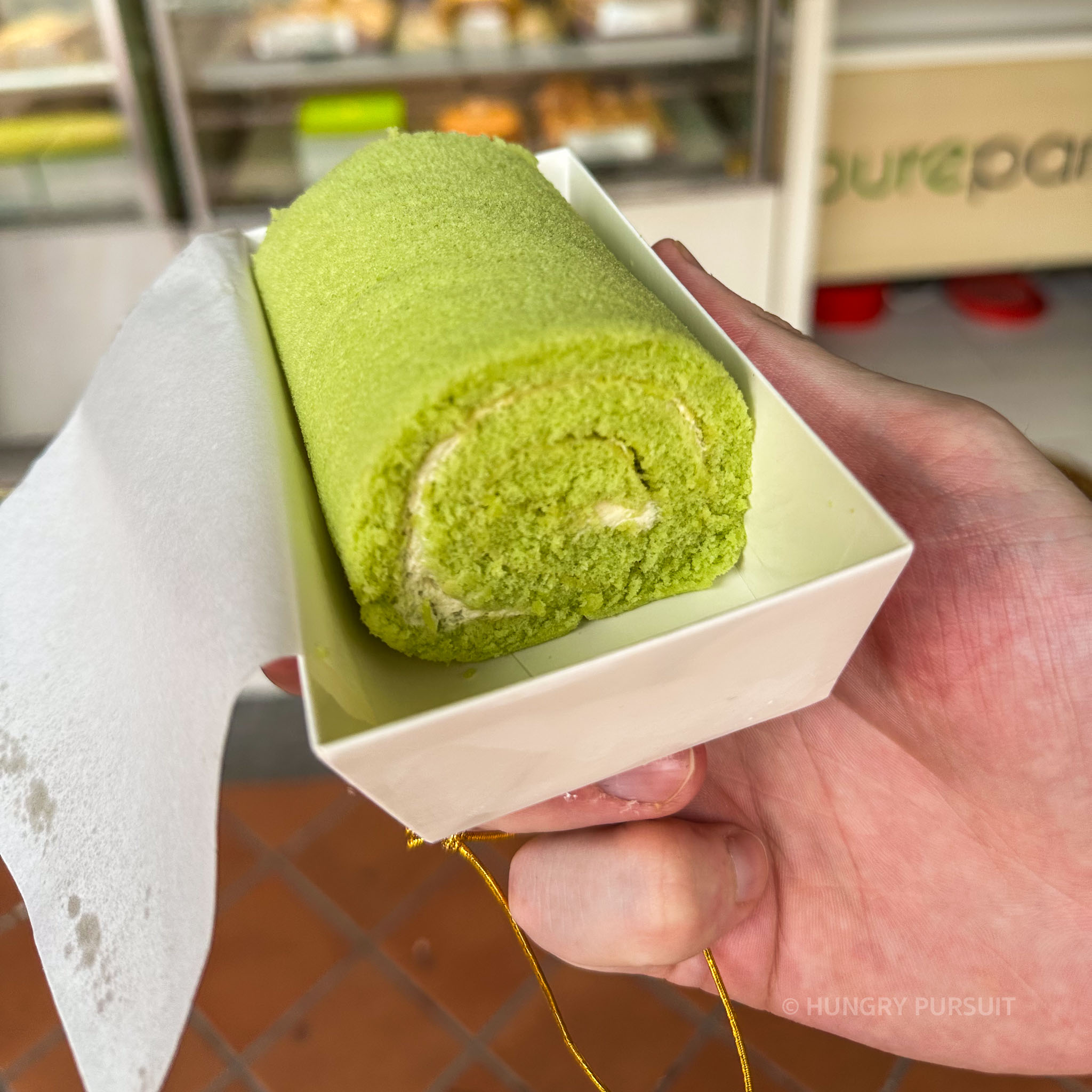 Close-up of Pandan Kaya Swiss Roll, a delectable dessert showcasing layers of pandan-flavored sponge cake and creamy kaya filling