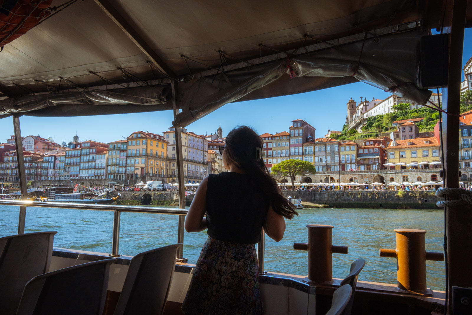 A woman observing the buildings on duoro river cruise, 1 day in Porto