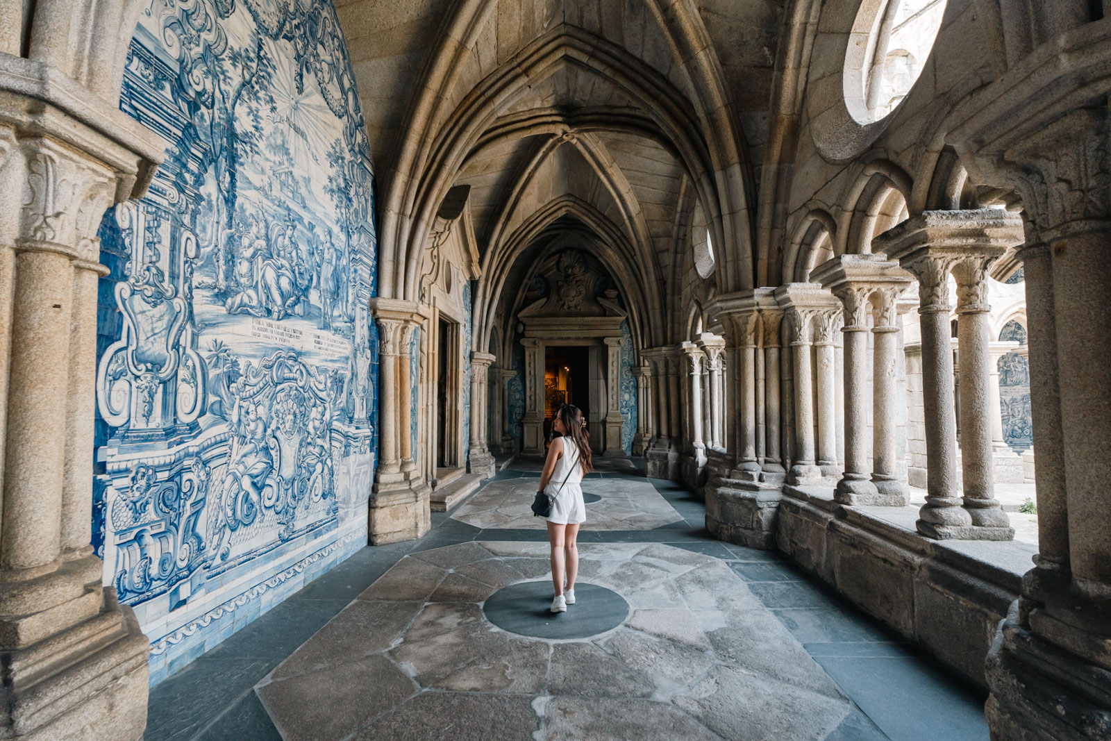 Porto Cathedral a woman standing in a hallway with a tile wall, 1 day in porto