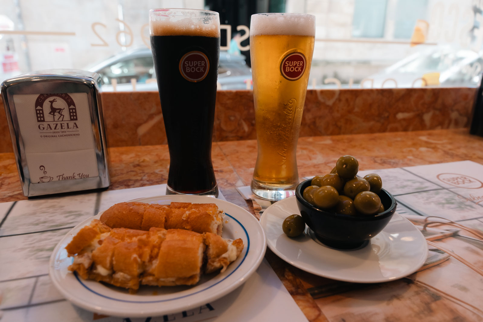 plate of Portuguese hot dog, and two beers, 1 day in Porto