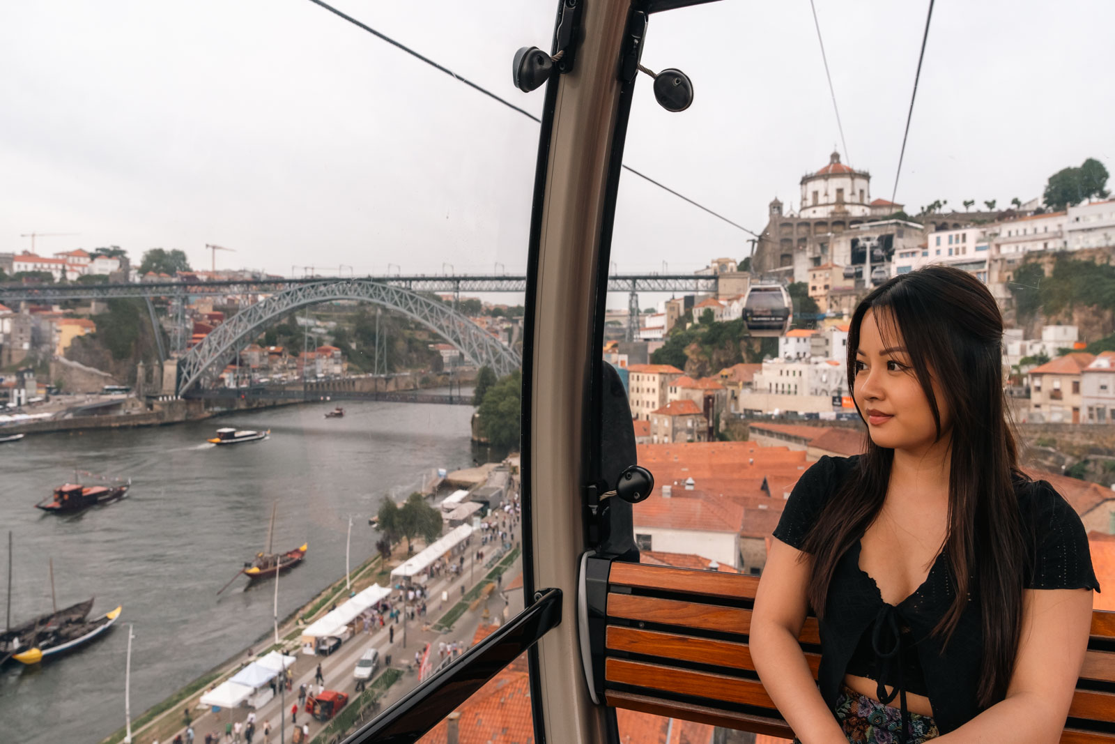 a woman sitting inside the funicular observing the view, 1 day in porto