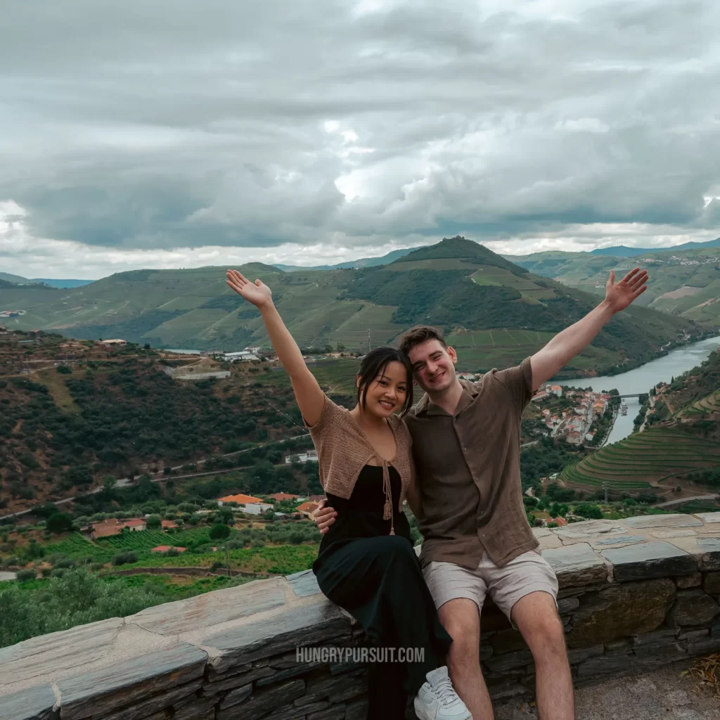 a man and woman posing at Miradouro Escritor Miguel Torga on best Douro valley wine tour