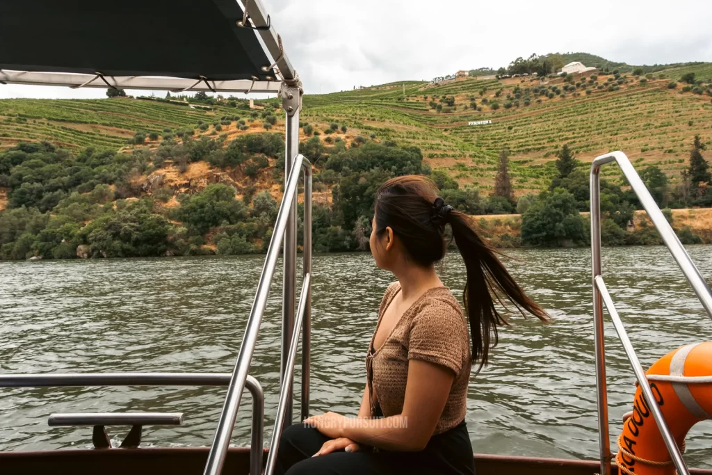 a woman sitting down on best douro valley wine tour tasting river cruise