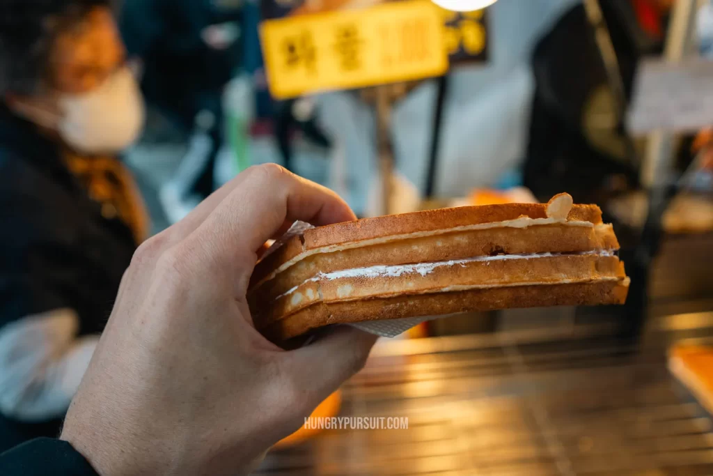 Busan itinerary BIFF Square eating an apple waffle korean street food