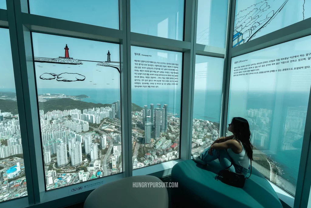 a woman reading the history of Busan X The Sky observatory