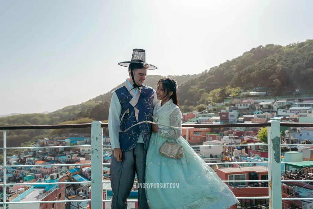 Couple posing in hanboks rental Busan itinerary Gamcheon Culture Village Korea Things to do