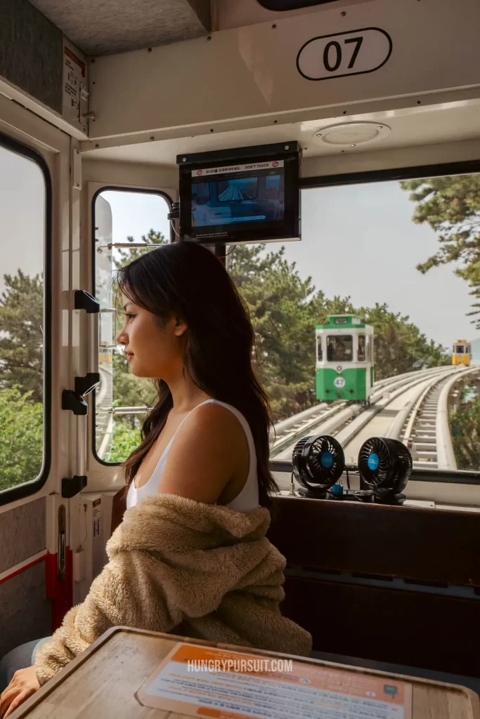 a woman inside haeundae sky capsule; haeundae blueline park photos