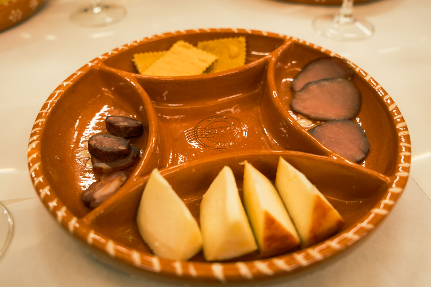 a plate of meats and cheese on a food tour; 2 days in porto itinerary