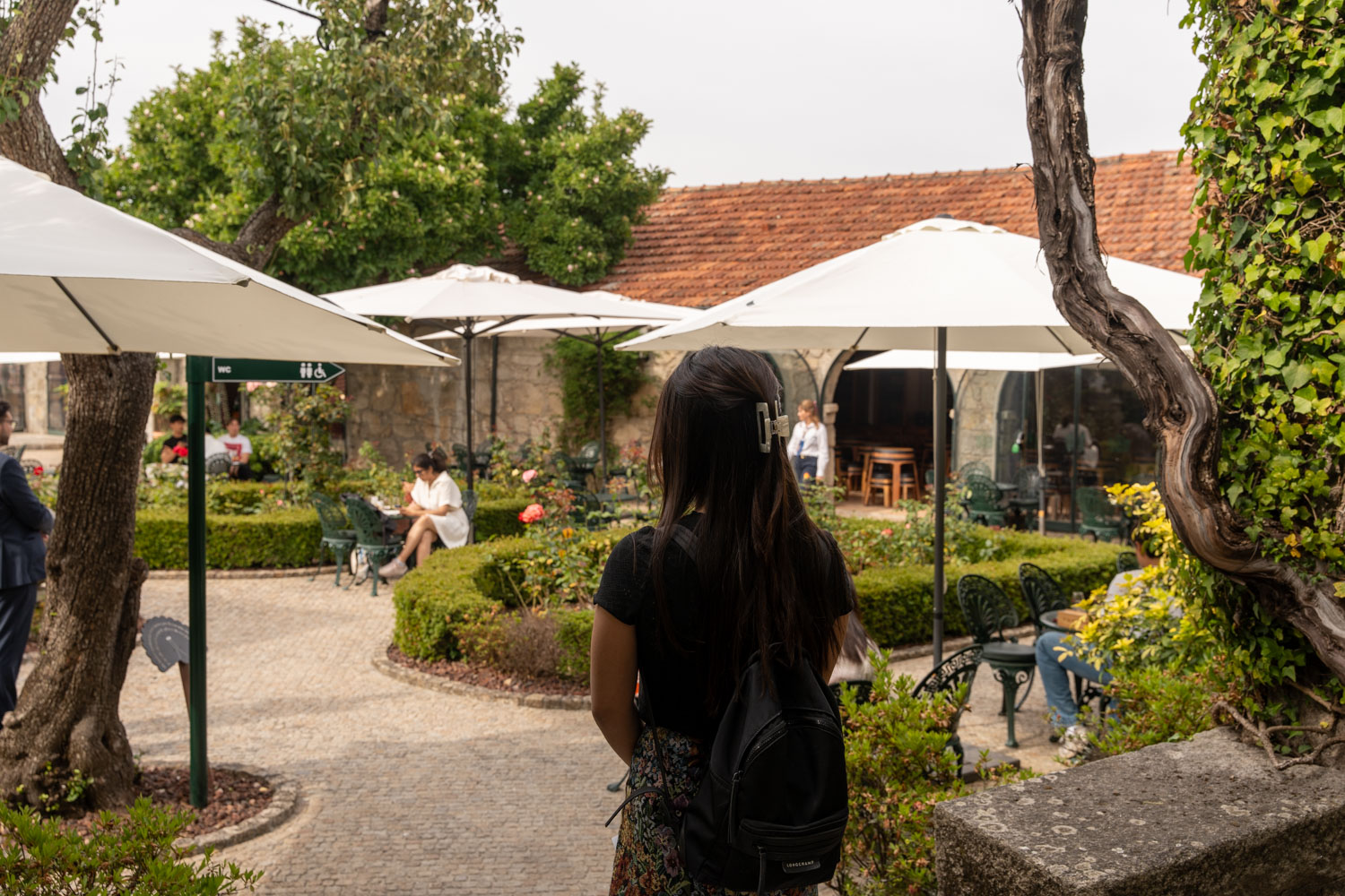 a woman walking in courtyard to the wine tasting at Taylors Port wine house; 2 days in Porto itinerary